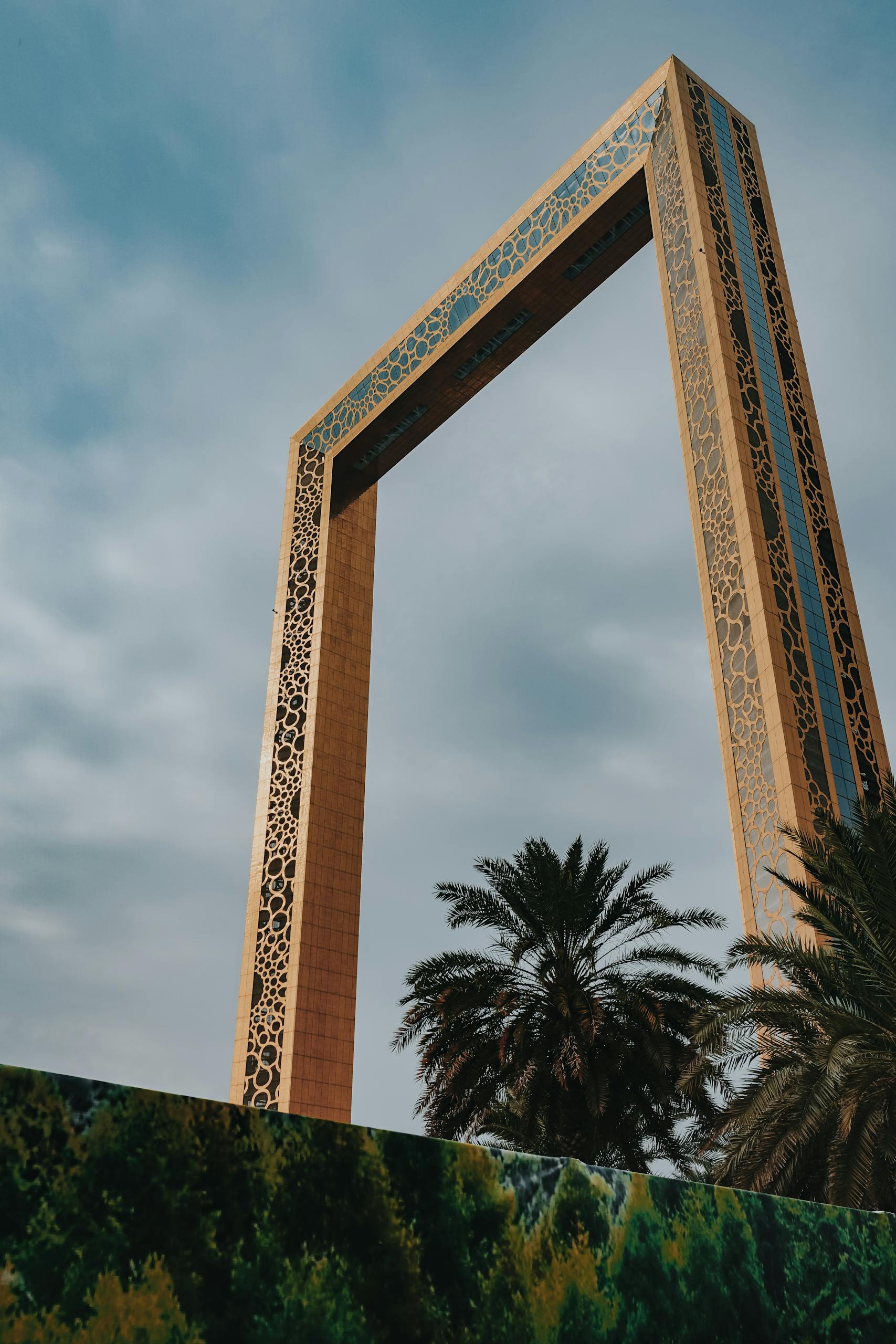 From below exterior of creative contemporary construction build in shape of rectangular photo frame in Dubai UAE on clear hot day